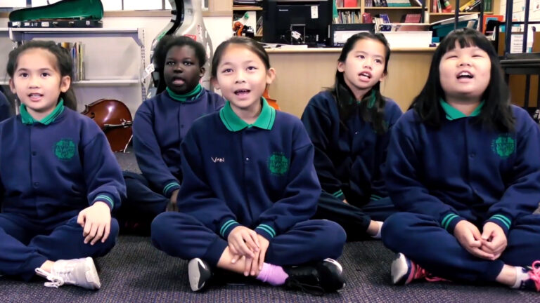 primary school students enjoying music arts learning lesson