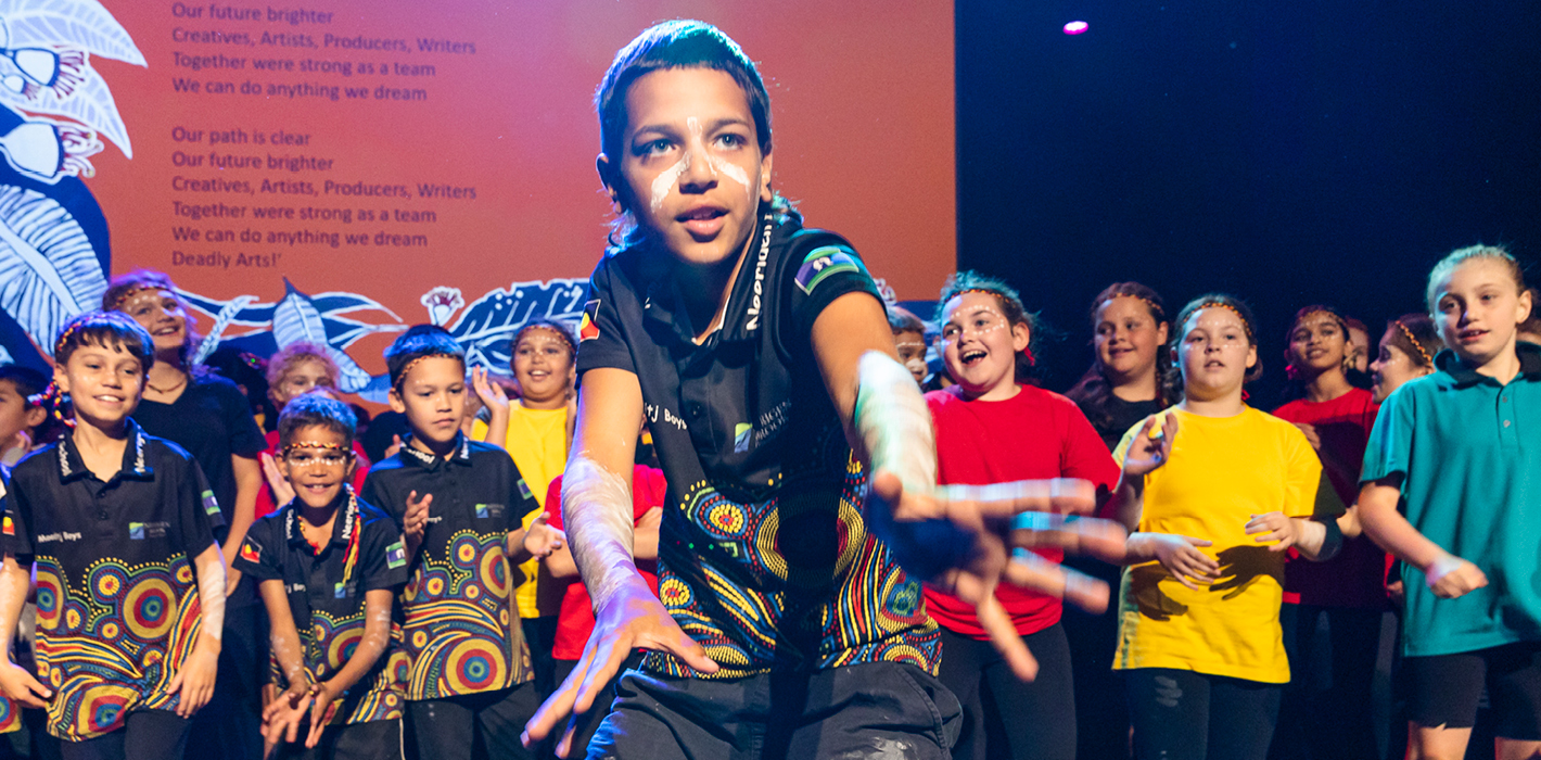 Primary school students engaged in first nations dance arts learning performance
